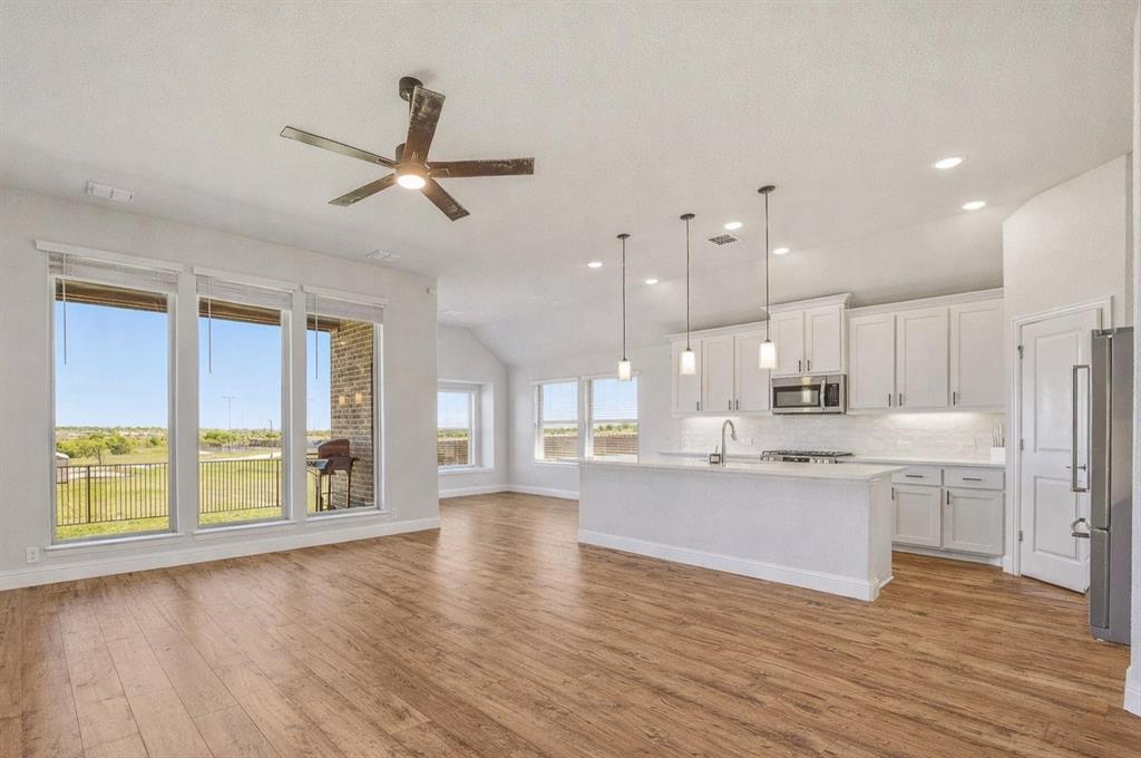 800 Jaguar Ridge Godley, TX 76044 - Photo 2 of 23 a large kitchen with a lot of counter space and wooden floor