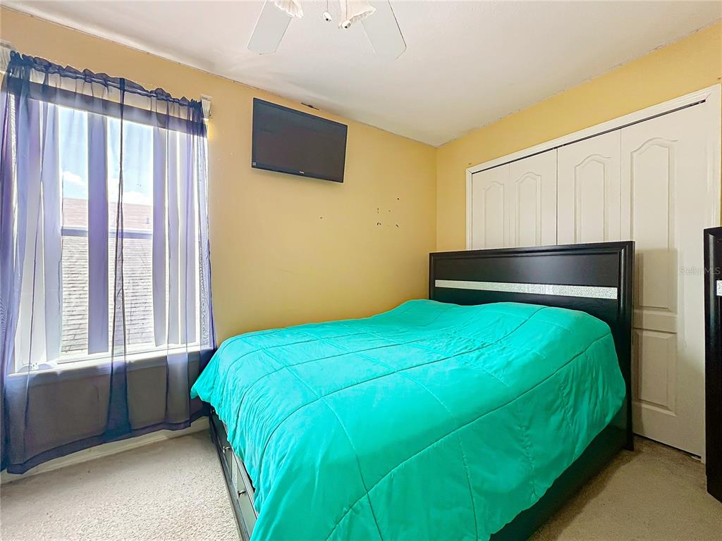 7939 Riffle Lane Orlando, FL 32818 - Photo 33 of 52 a bedroom with a bed and a window