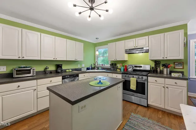 a kitchen with a stove a sink and a refrigerator