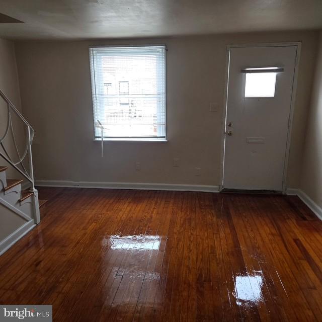 4816 Alcott Street Philadelphia, PA 19135 - Photo 2 of 6 an empty room with wooden floor and windows
