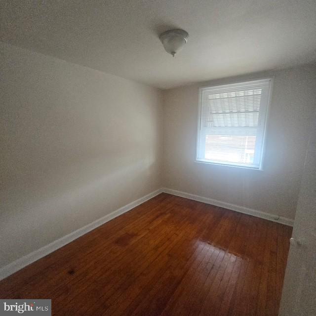 4816 Alcott Street Philadelphia, PA 19135 - Photo 3 of 6 an empty room with wooden floor and windows