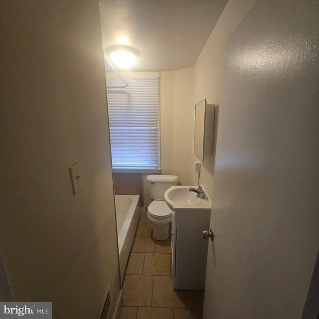 4816 Alcott Street Philadelphia, PA 19135 - Photo 5 of 6 a bathroom with a sink a toilet and mirror