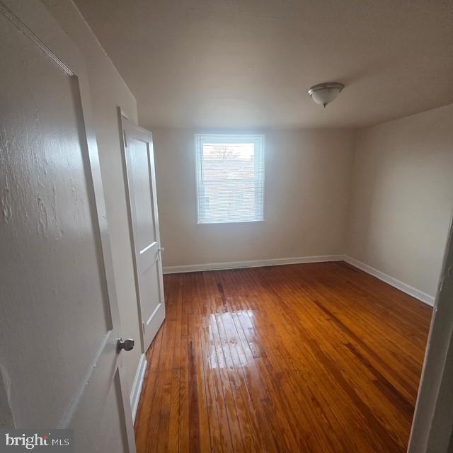 4816 Alcott Street Philadelphia, PA 19135 - Photo 6 of 6 an empty room with wooden floor and windows