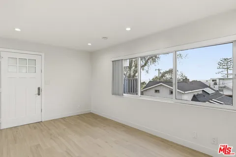 a view of a livingroom with wooden floor and a window