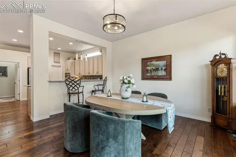 a view of a kitchen area with furniture and wooden floor