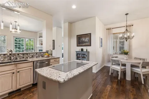 a kitchen with center island table and chairs