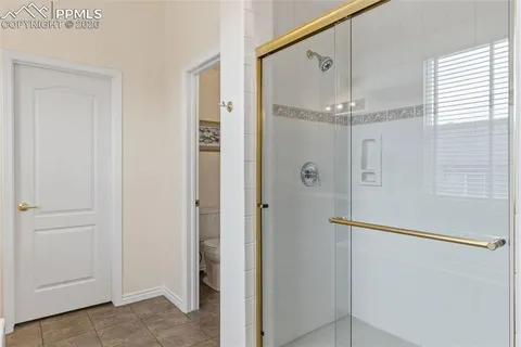 a bathroom with a glass shower door and a bathtub