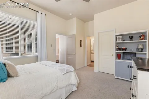a spacious bedroom with a bed and a window