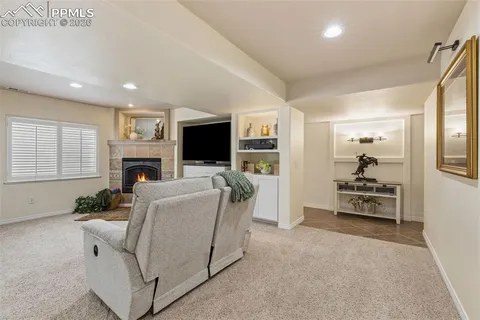 a living room with furniture a fireplace and a flat screen tv