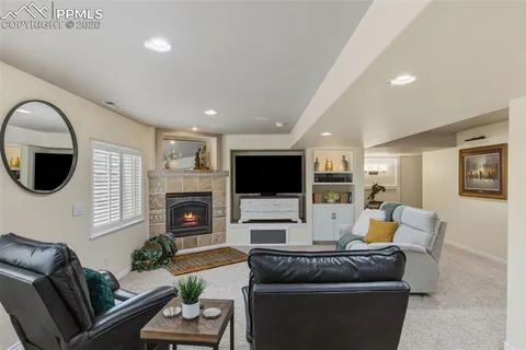 a living room with fireplace furniture and a flat screen tv