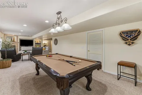 a room with furniture and pool table