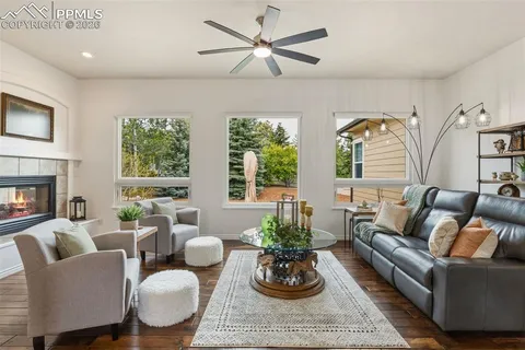 a living room with furniture potted plant and a large window