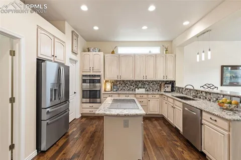 a kitchen with a refrigerator sink and stove