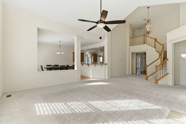 a kitchen with stainless steel appliances granite countertop a sink a microwave cabinets and a wooden floor