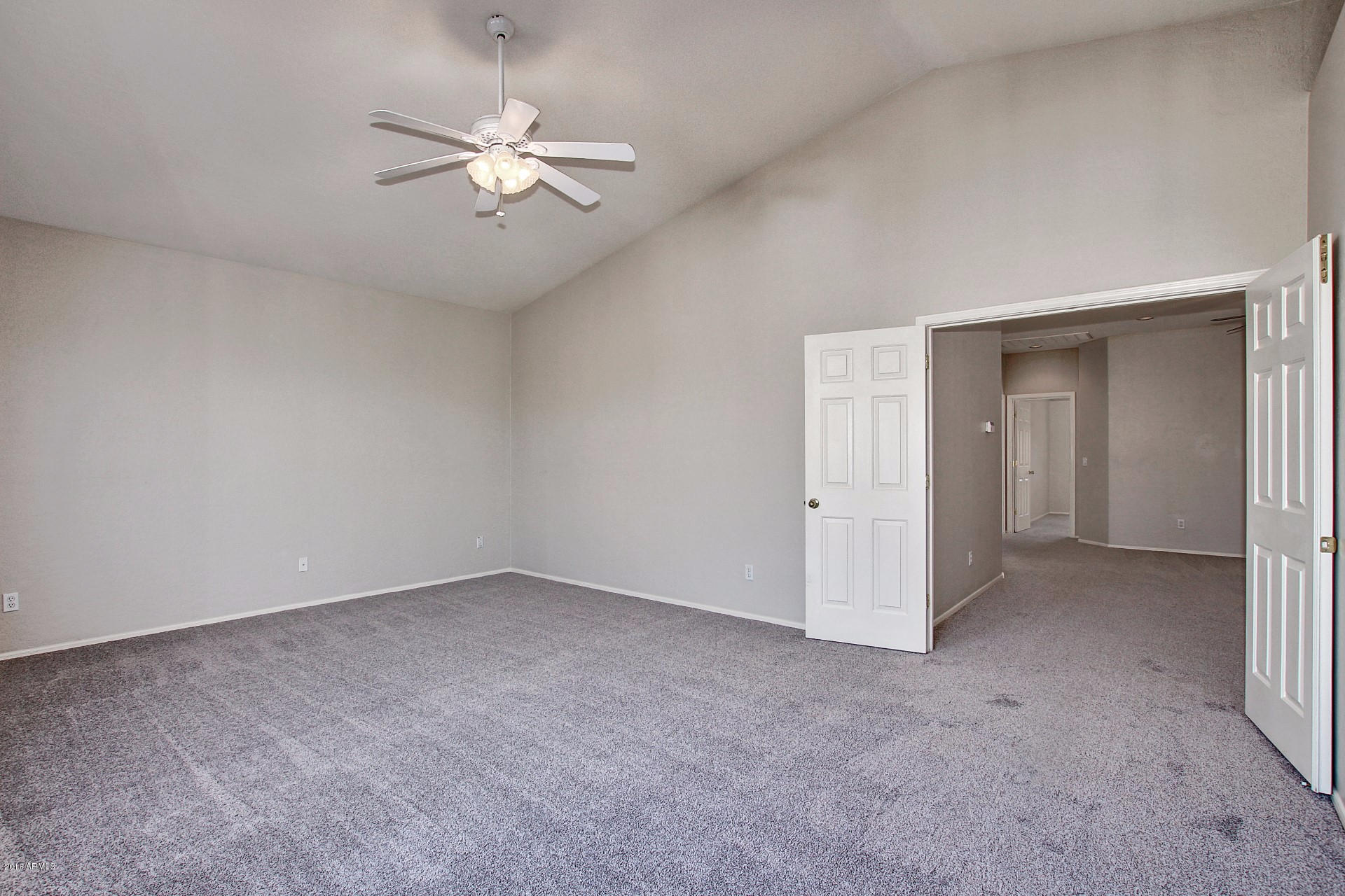 1360 East Harrison Street Gilbert, AZ 85295 - Photo 19 of 34 an empty room with chandelier fan and closet area