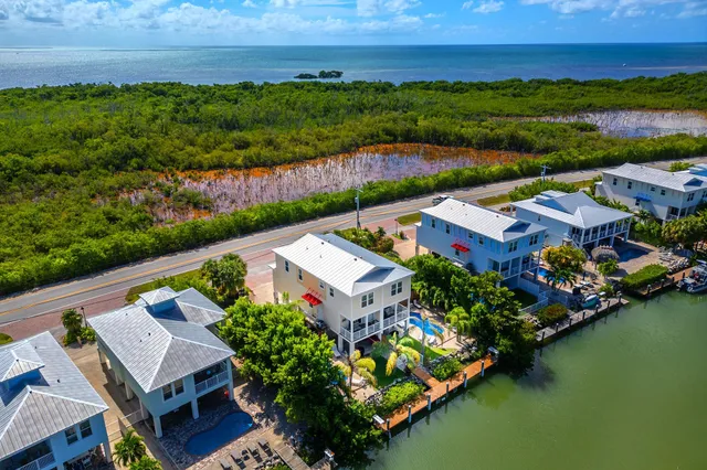 a view of backyard with swimming pool and outdoor seating