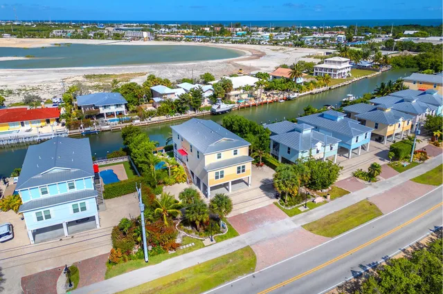 an aerial view of a house with a lake view