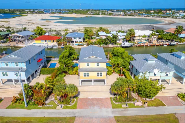 an aerial view of a house with a ocean view