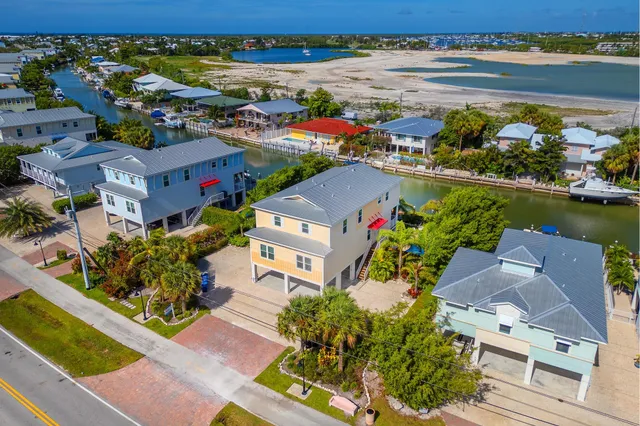 an aerial view of a house with a lake view