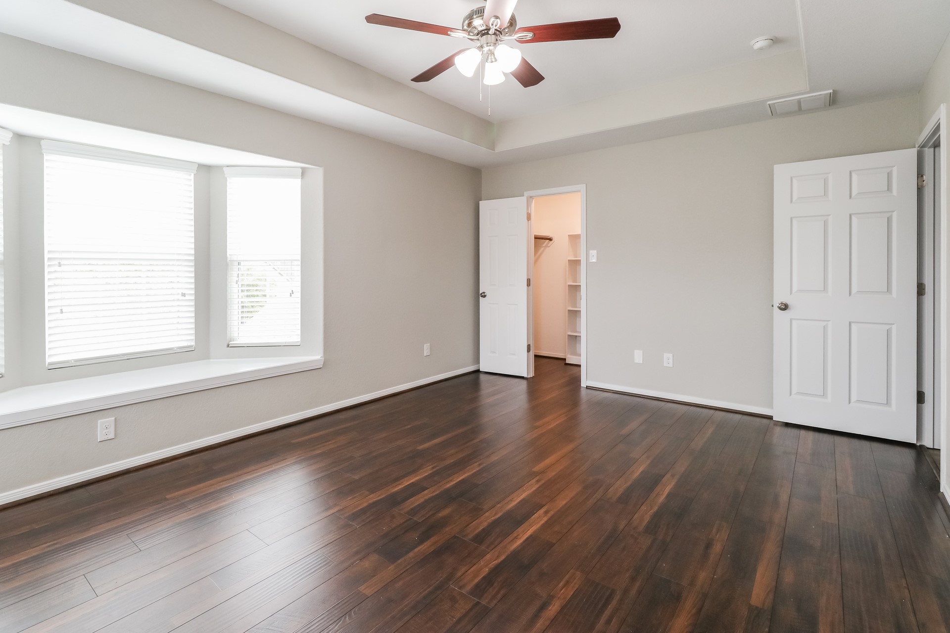 29331 Indian Clearing Spring, TX 77386 - Photo 11 of 17 an empty room with wooden floor chandelier fan and windows