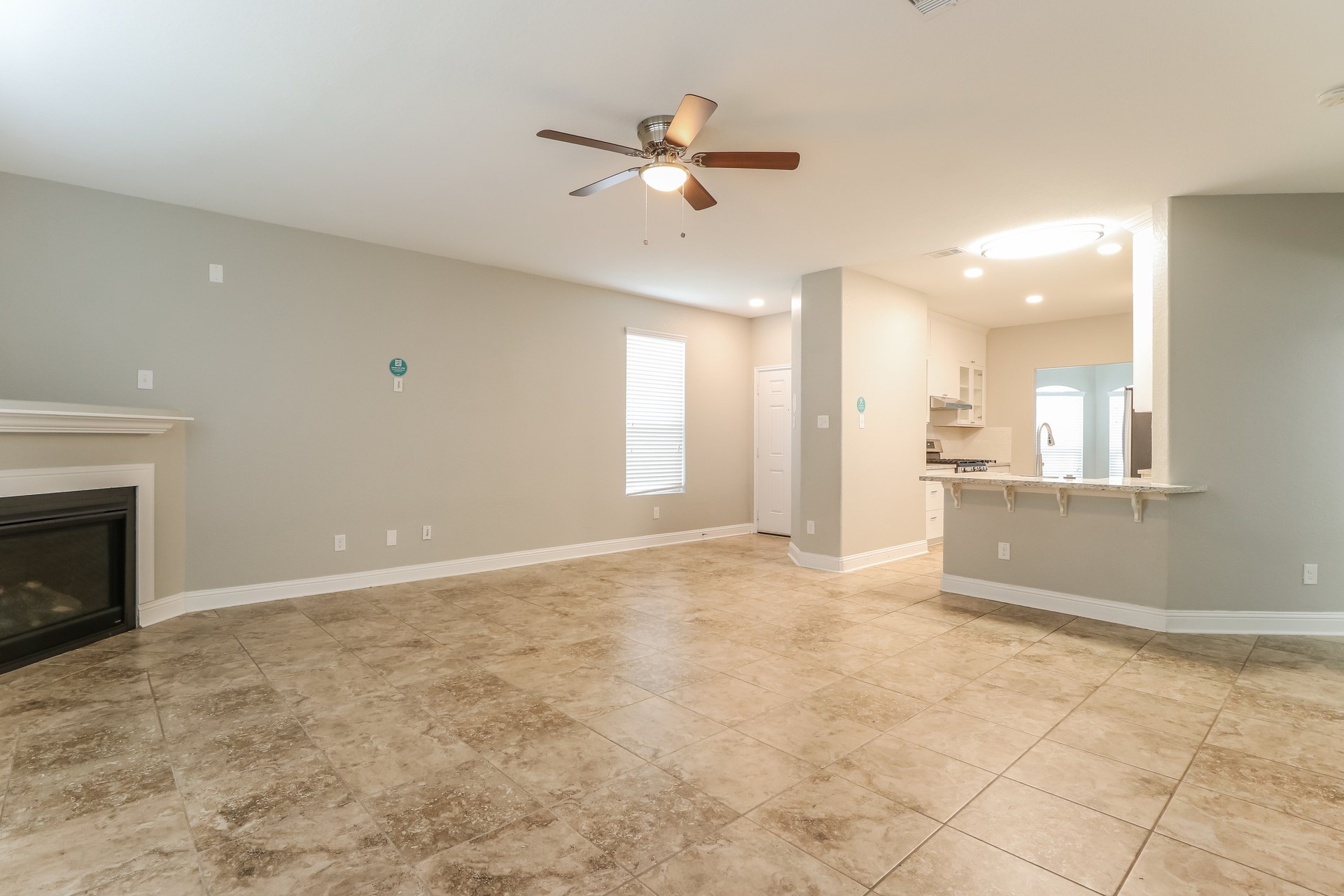 29331 Indian Clearing Spring, TX 77386 - Photo 4 of 17 a view of an empty room with a fireplace and a ceiling fan