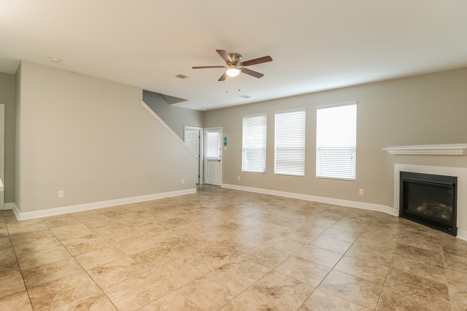 29331 Indian Clearing Spring, TX 77386 - Photo 5 of 17 a view of an empty room with a fireplace and a window