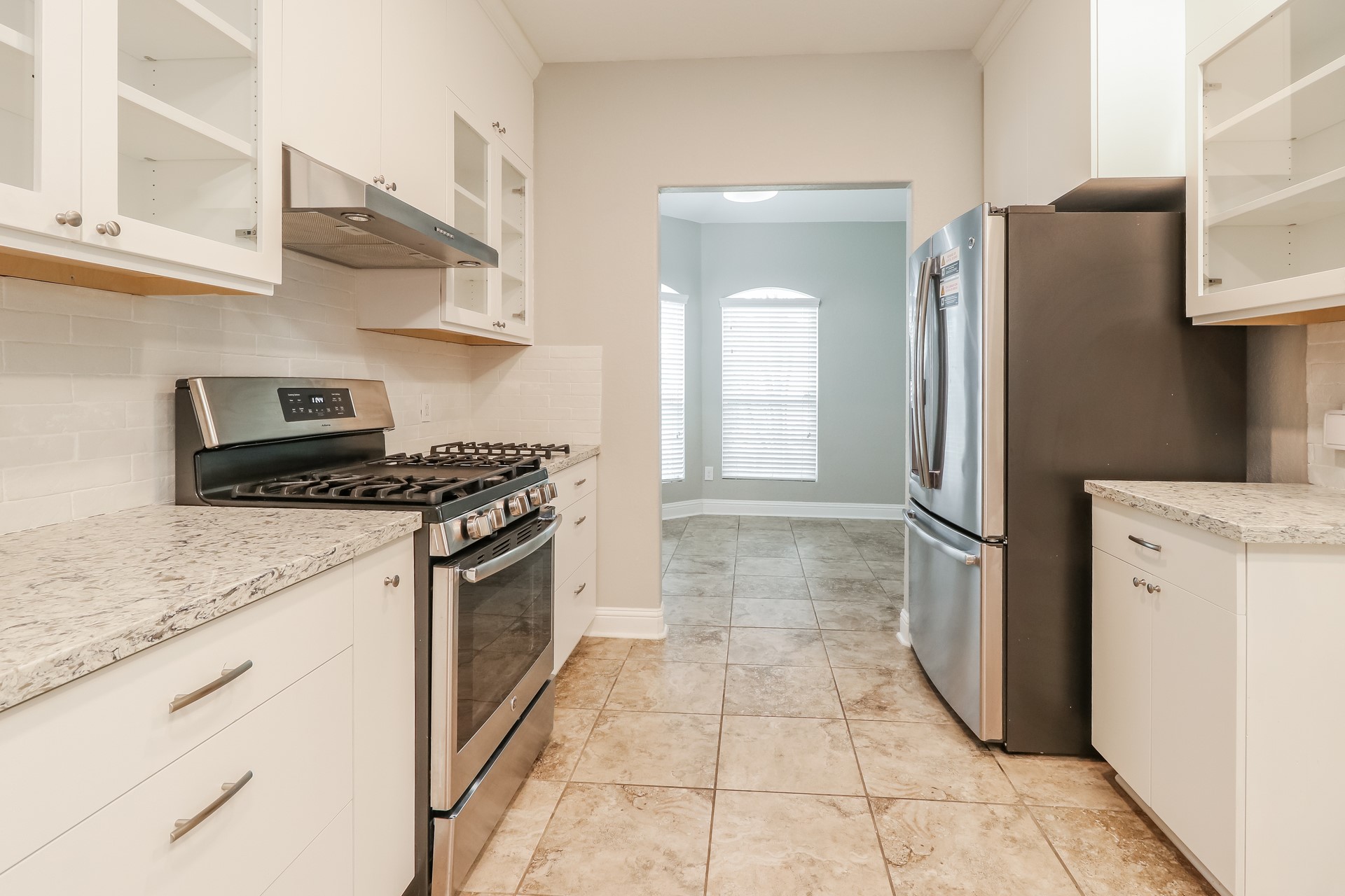 29331 Indian Clearing Spring, TX 77386 - Photo 10 of 17 a kitchen with a refrigerator and a stove top oven