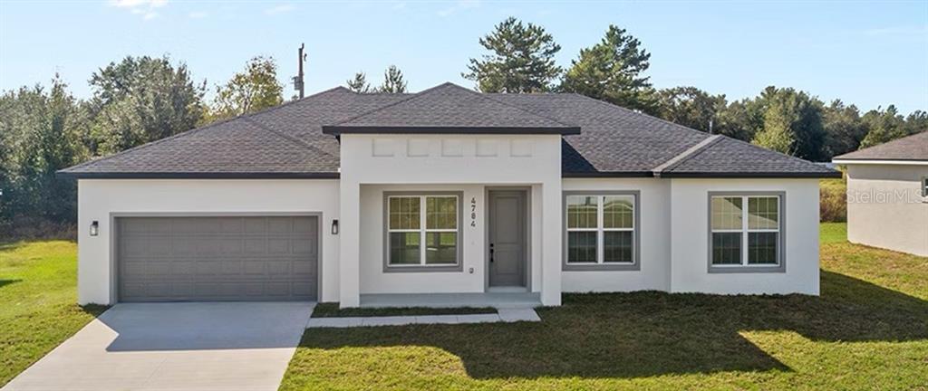 6084 Southwest 150th Lane Road Ocala, FL 34473 - Photo 1 of 1 a front view of a house with a yard