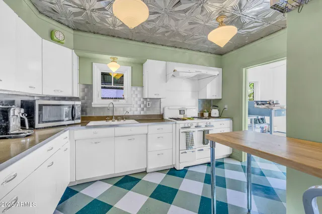 a kitchen with a sink stove and cabinets
