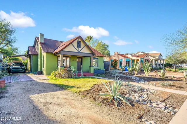 a view of a house with swimming pool and sitting area