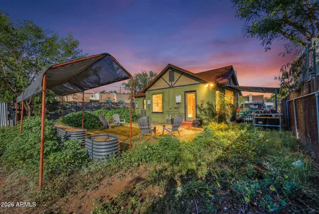 a front view of a house with swimming pool having outdoor seating