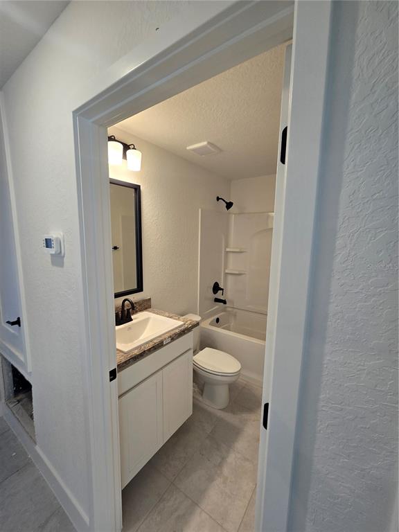 2525 Clearwood Street Inverness, FL 34452 - Photo 12 of 17 a bathroom with a granite countertop sink mirror vanity and toilet