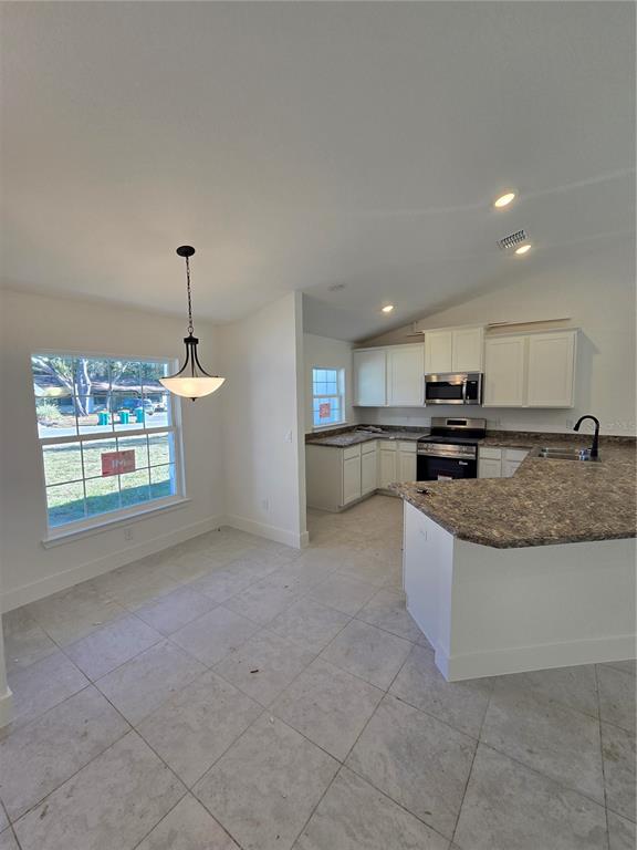 2525 Clearwood Street Inverness, FL 34452 - Photo 7 of 17 a large kitchen with stainless steel appliances granite countertop a sink and a stove