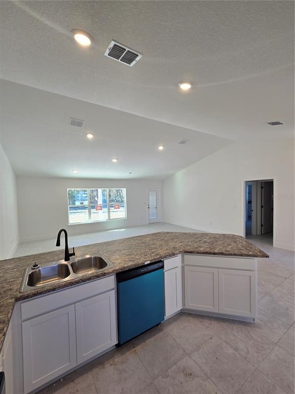 2525 Clearwood Street Inverness, FL 34452 - Photo 8 of 17 a kitchen with granite countertop a sink and white cabinets
