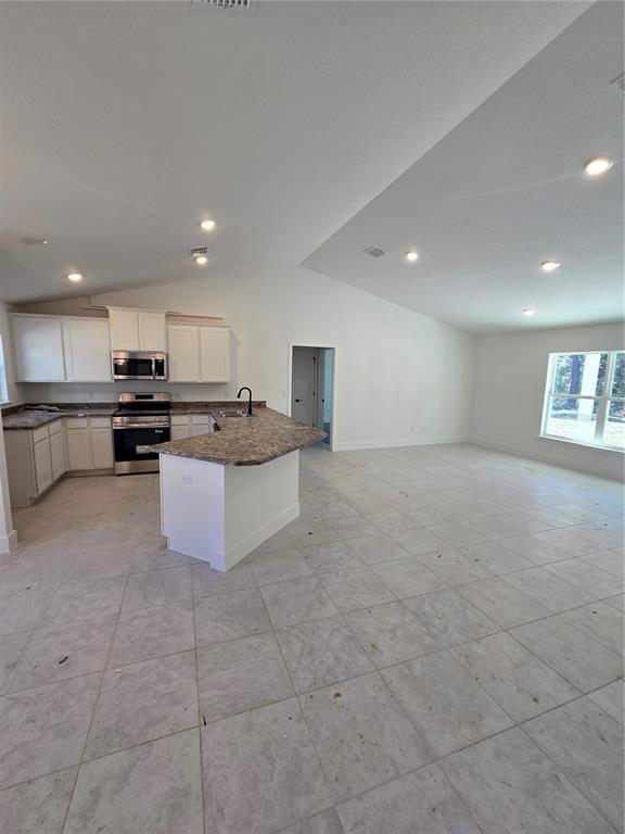 2525 Clearwood Street Inverness, FL 34452 - Photo 9 of 17 a kitchen with stainless steel appliances granite countertop a stove top oven a sink and a refrigerator