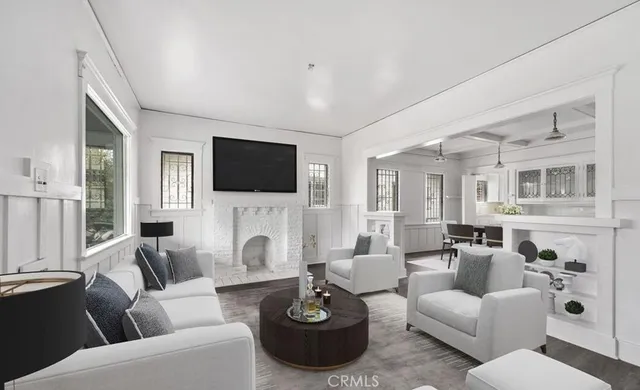 a living room with furniture a fireplace and a flat screen tv