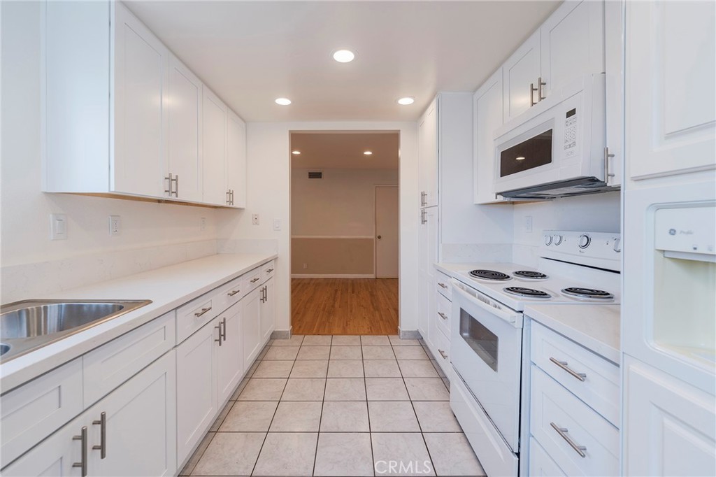 263 Tarocco Irvine, CA 92618 - Photo 13 of 34 a kitchen with stainless steel appliances granite countertop a sink and a stove