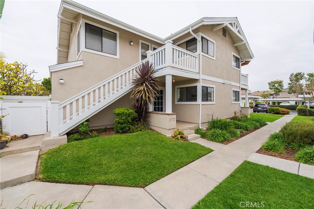 263 Tarocco Irvine, CA 92618 - Photo 2 of 34 a view of a white house next to a yard with plants and a large tree