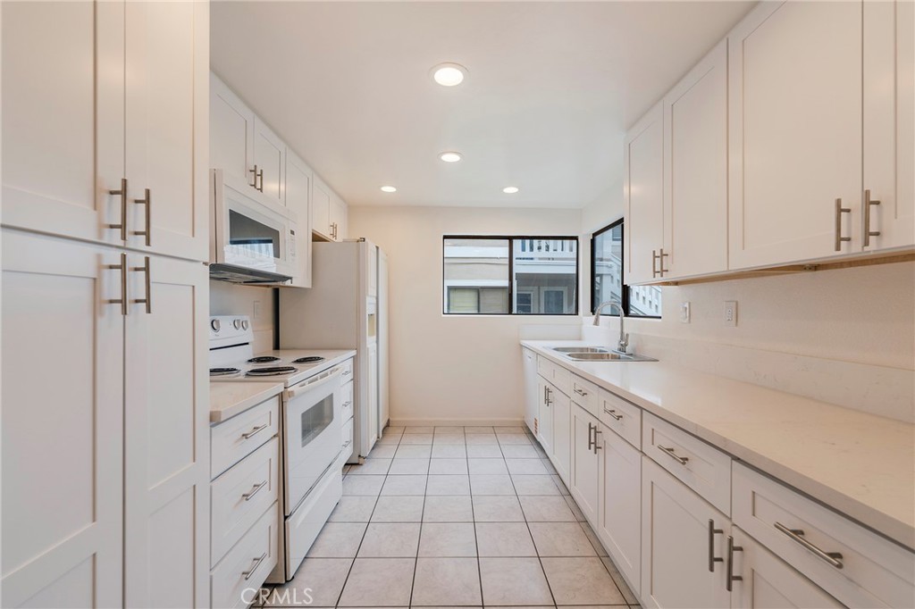 263 Tarocco Irvine, CA 92618 - Photo 8 of 34 a kitchen with white cabinets and appliances