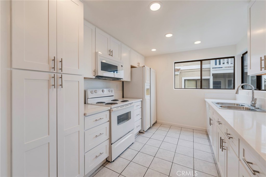 263 Tarocco Irvine, CA 92618 - Photo 9 of 34 a kitchen with stainless steel appliances granite countertop a stove a sink and a refrigerator
