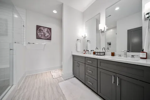 a spacious bathroom with a double vanity sink and a mirror