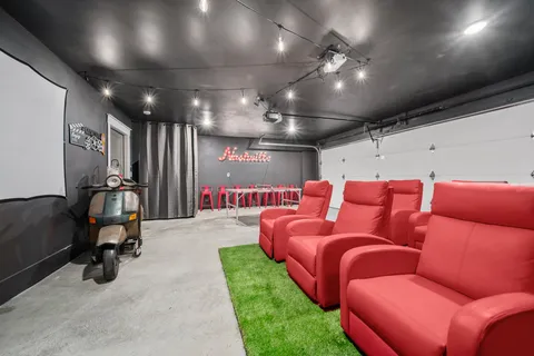 a media room with lots of chairs and a projector