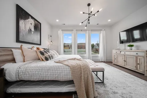 a bedroom with a bed and a flat screen tv
