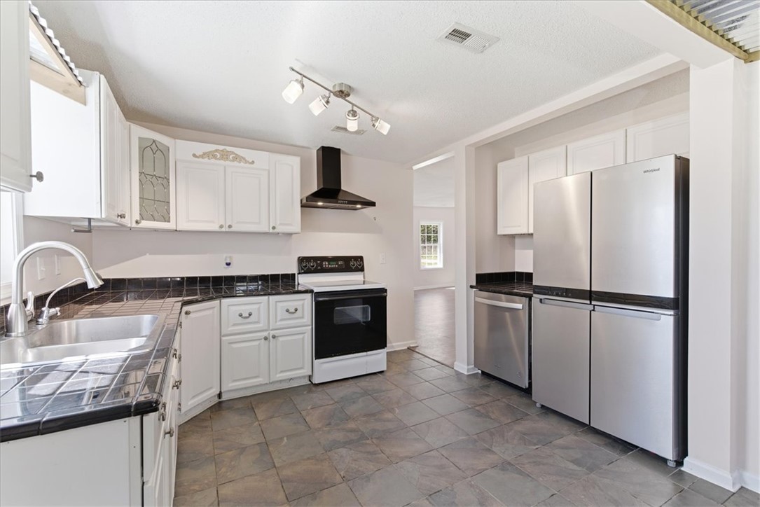 112 Newry Road Seneca, SC 29672 - Photo 4 of 19 This functional kitchen features ample cabinet space, modern appliances, and durable flooring, perfect for daily living.