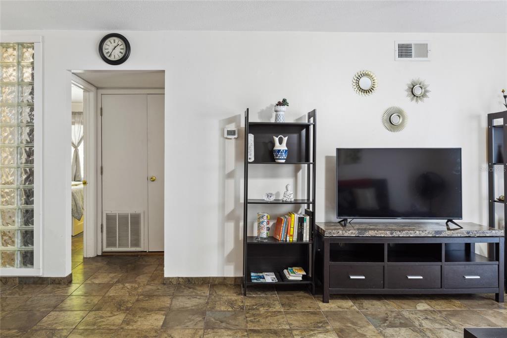 1700 Southwest 16th Court, Unit M2 Gainesville, FL 32608 - Photo 2 of 13 a living room with furniture and a flat screen tv