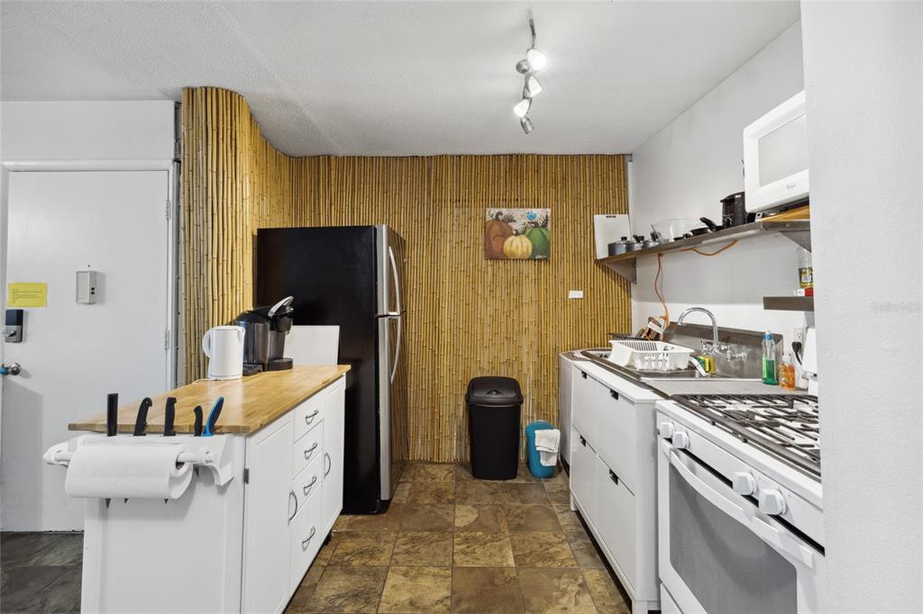 1700 Southwest 16th Court, Unit M2 Gainesville, FL 32608 - Photo 7 of 13 a kitchen with a sink stove and refrigerator