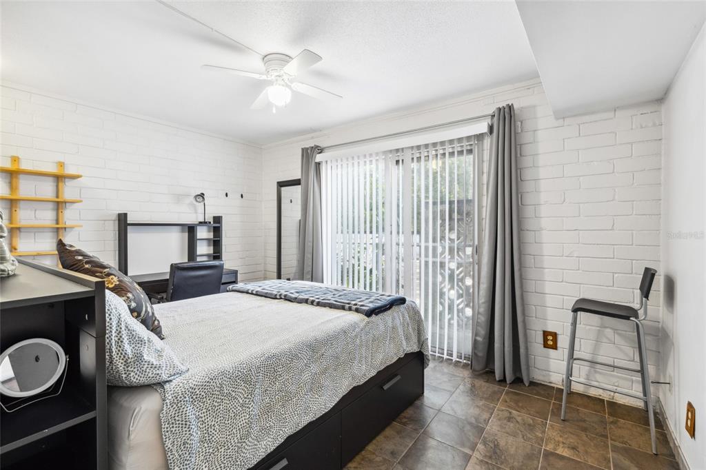 1700 Southwest 16th Court, Unit M2 Gainesville, FL 32608 - Photo 8 of 13 a bedroom with a bed and a cabinets