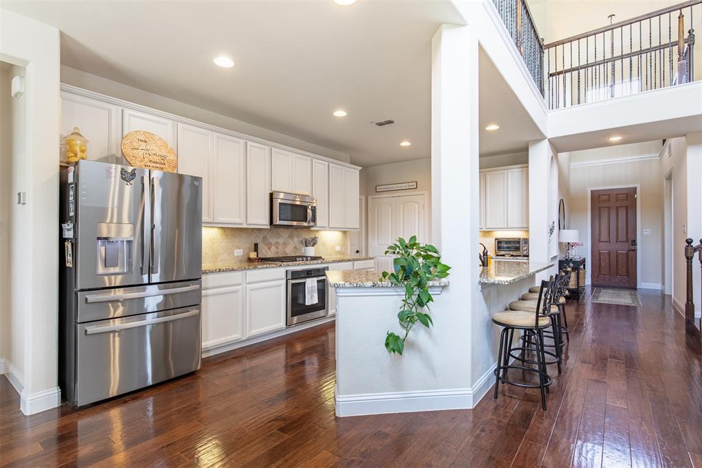 717 Rio Concho Trail McKinney, TX 75071 - Photo 14 of 37 Spacious kitchen with bar top.