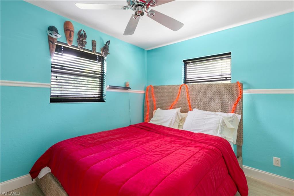 19053 Holly Road Fort Myers, FL 33967 - Photo 1 of 21 a bed room with a bed and a chandelier