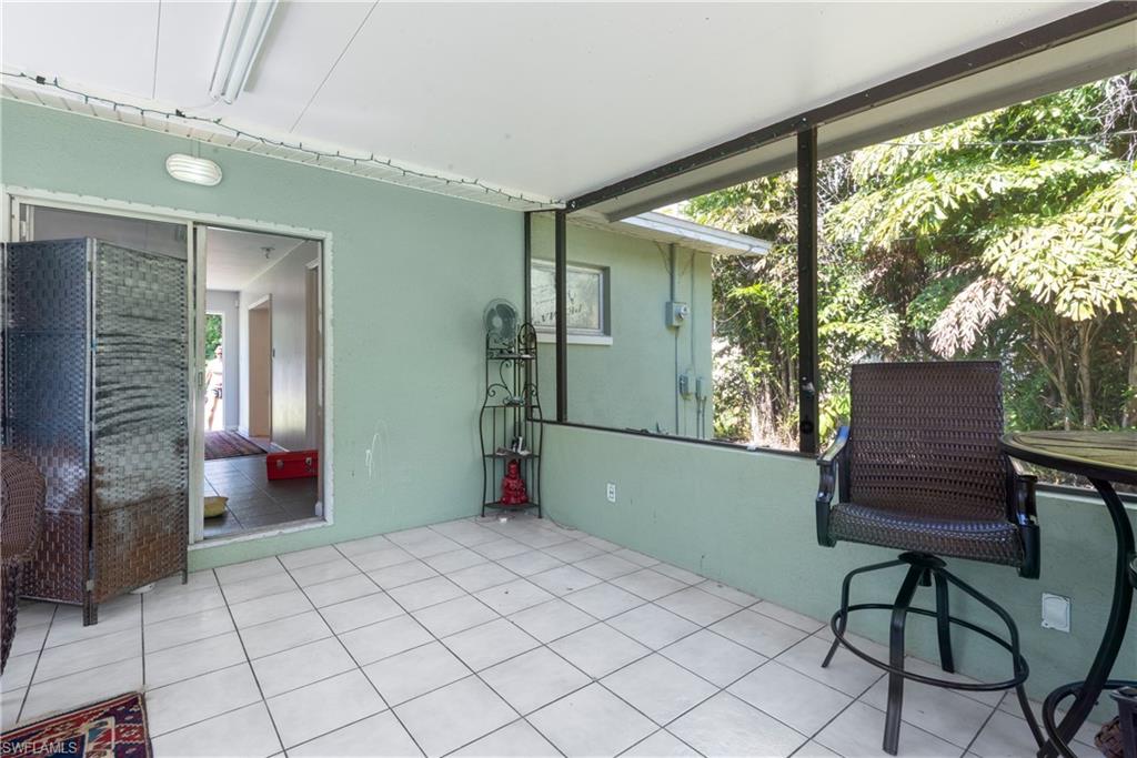 19053 Holly Road Fort Myers, FL 33967 - Photo 13 of 21 a bedroom with furniture and a window